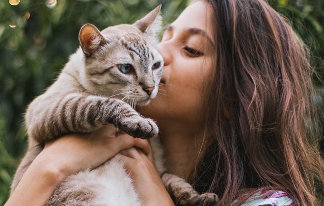 girl kissing her cat